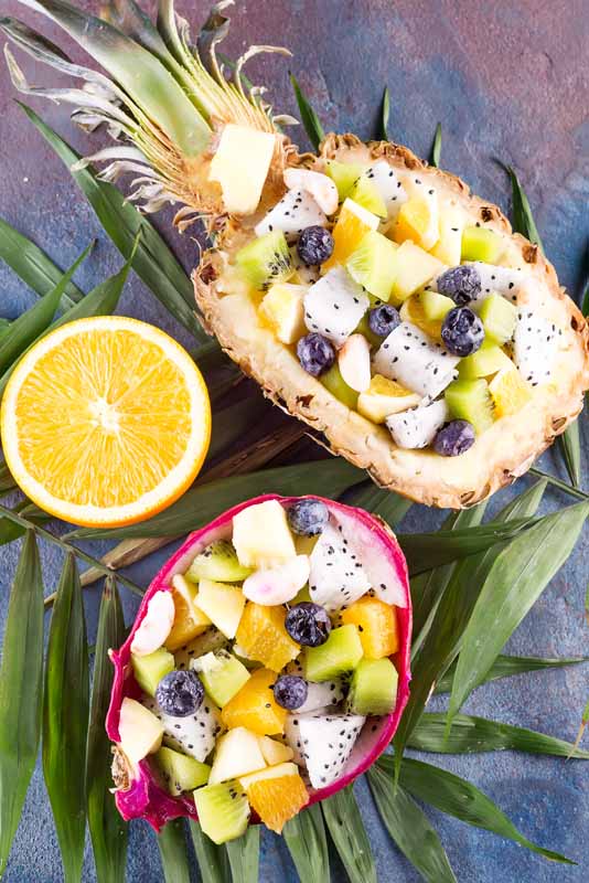 Exotic fruit salad served in half a dragon fruit