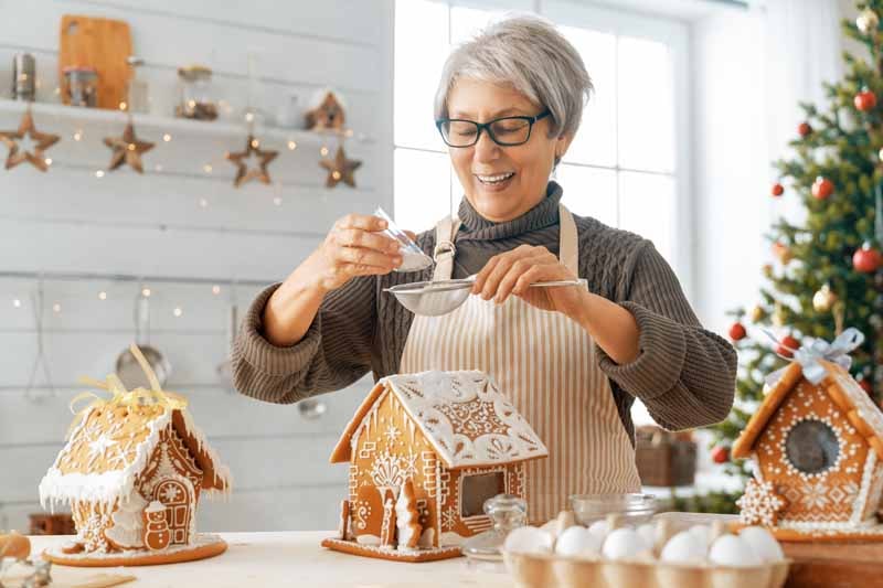 woman-cooking-gingerbread-house