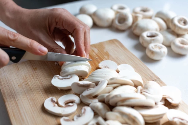 White Mushroom Cutting on Table