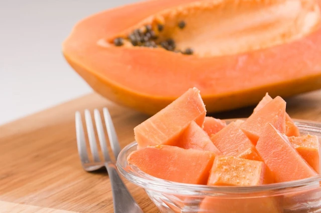 ut papaya on a wooden board